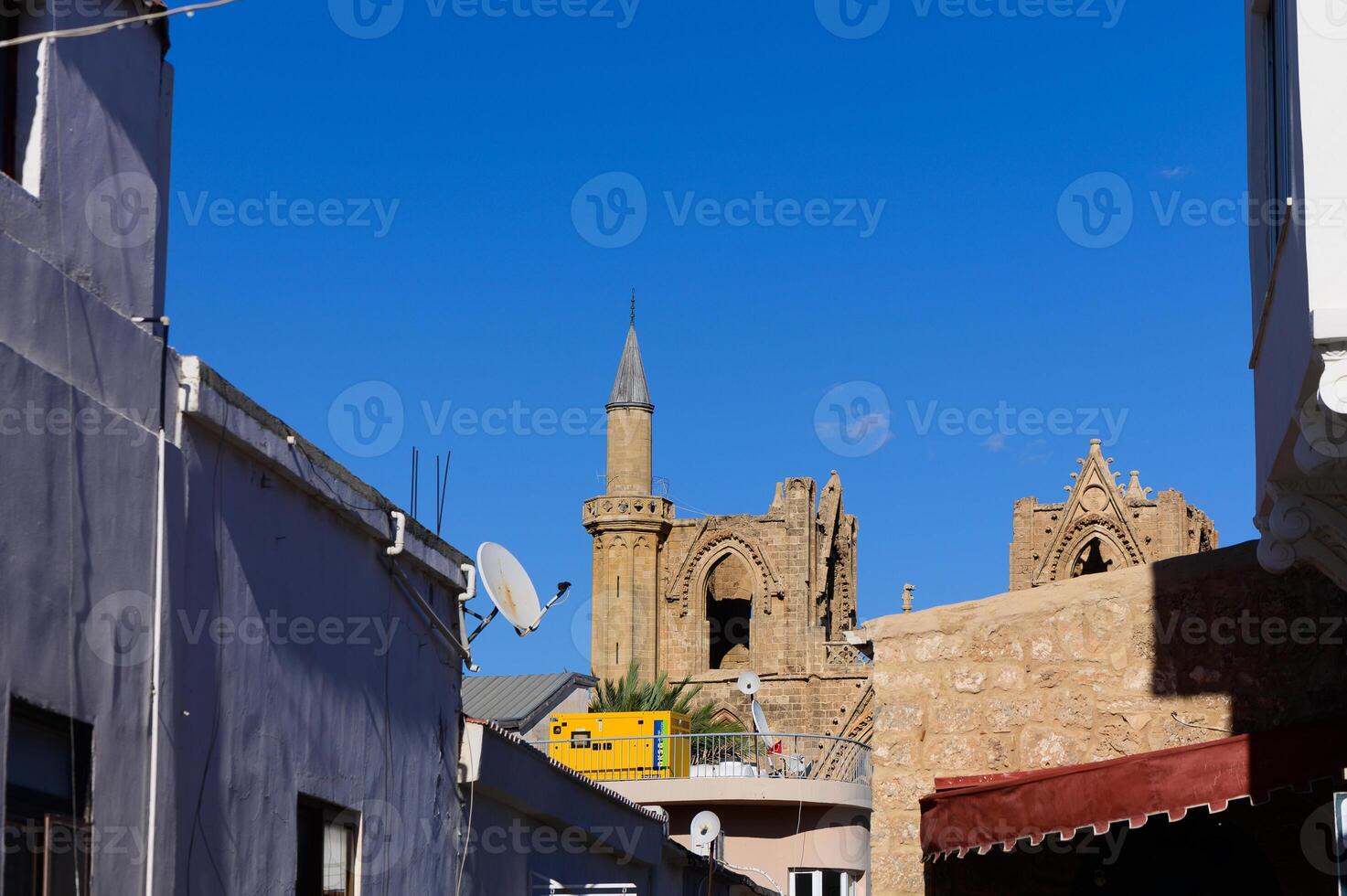 Exploring the historic architecture of an ancient church against a clear blue sky in a quaint town photo