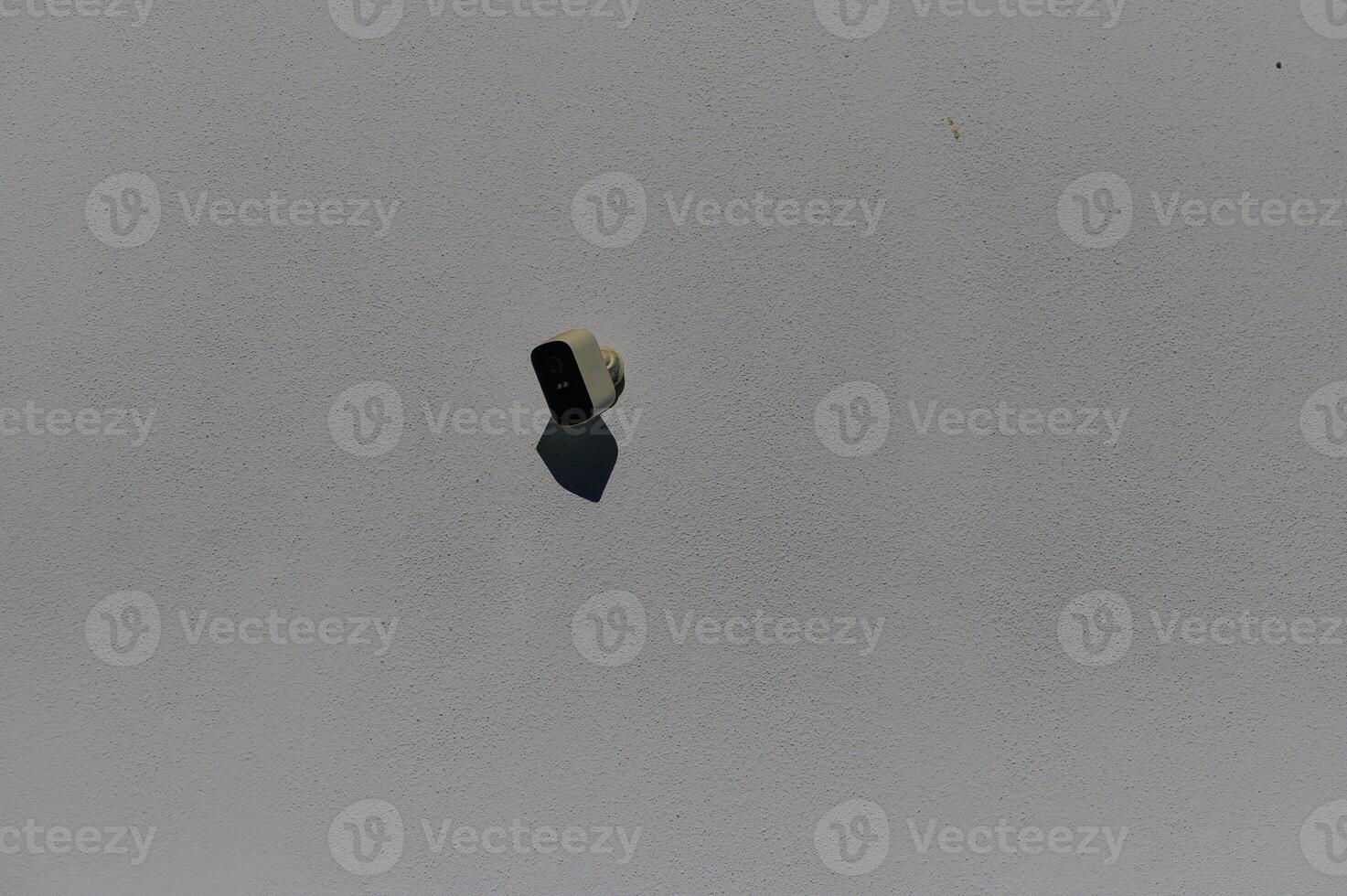 A solitary paintbrush floating above a pale surface, capturing a moment of artistic inspiration in the studio photo