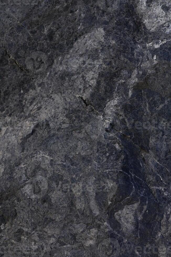Natural grey stone texture showcasing intricate patterns with subtle veining and earthy tones in natural light photo