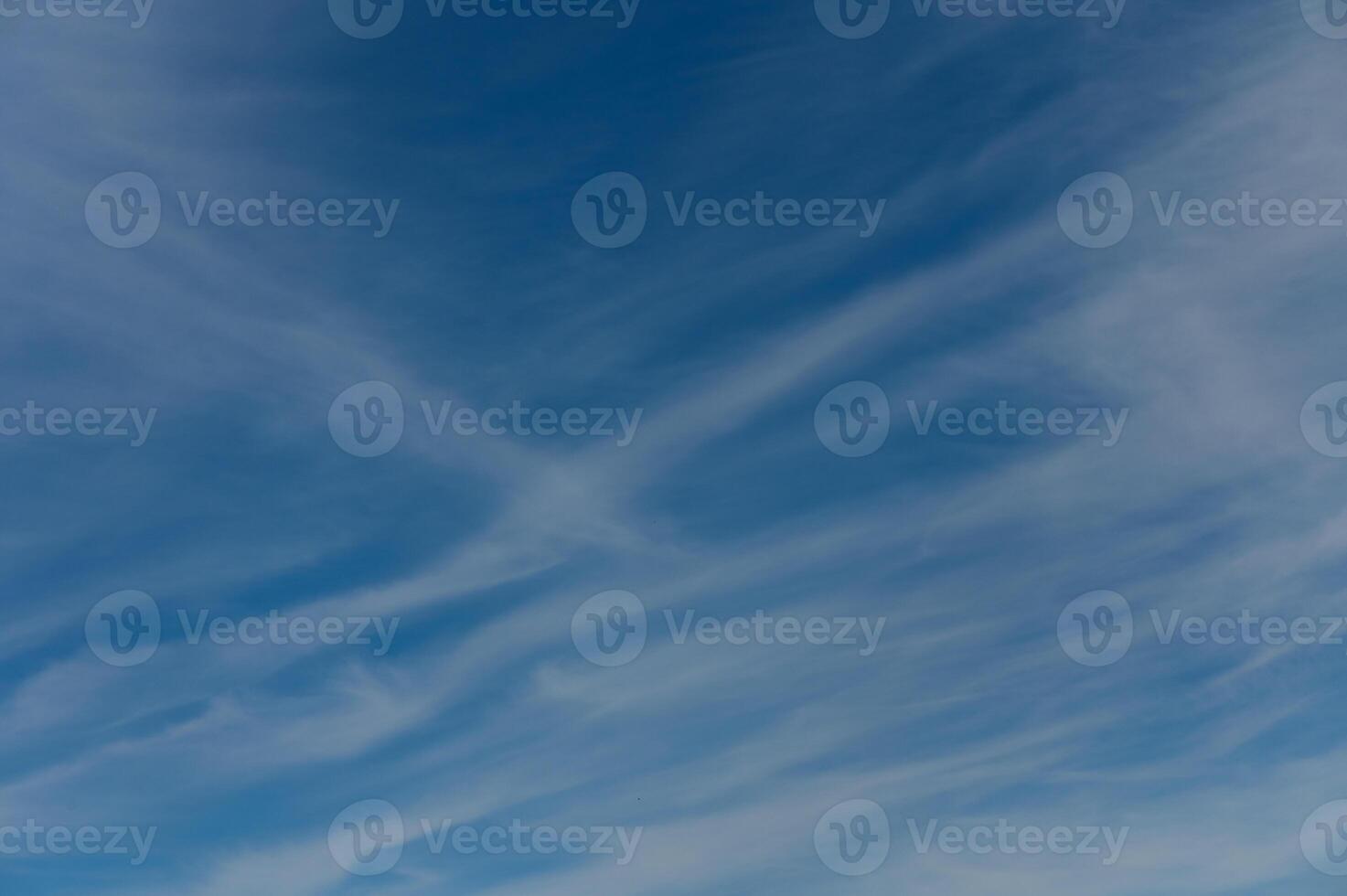 Wispy clouds dance across the azure sky during a tranquil afternoon in nature embrace photo