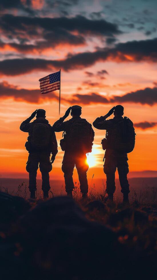 Soldiers salute at sunset while honoring their country with a flag in a mountainous location photo