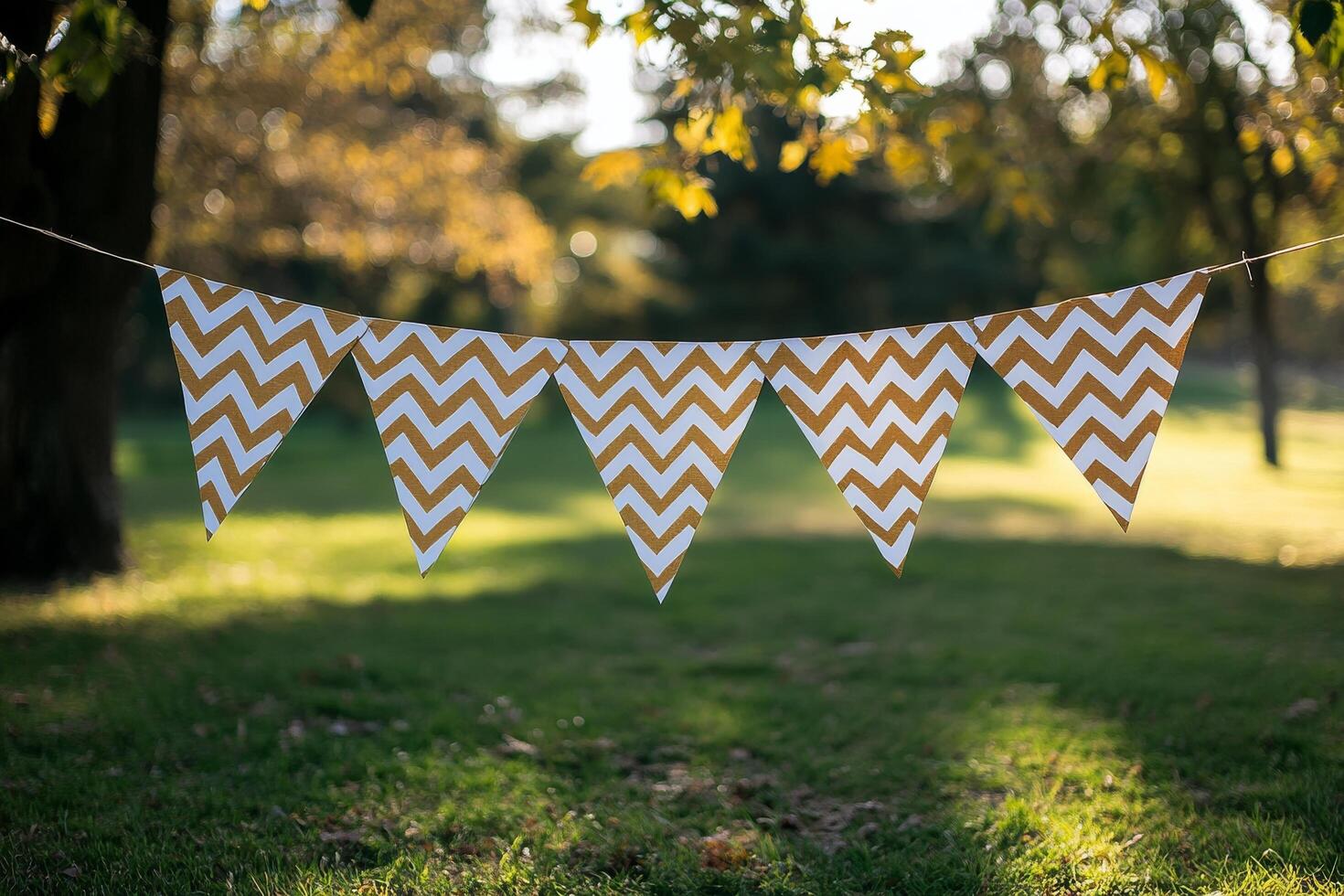 Colorful chevron bunting decorations hanging in a sunny park during a bright afternoon photo