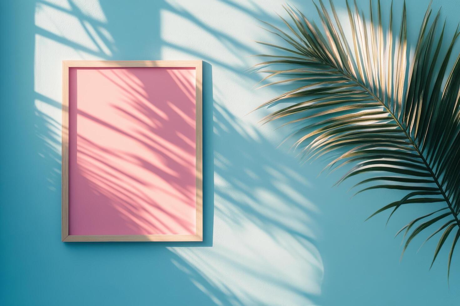 Colorful square canvas against a bright blue wall with palm shadows in a sunny environment photo