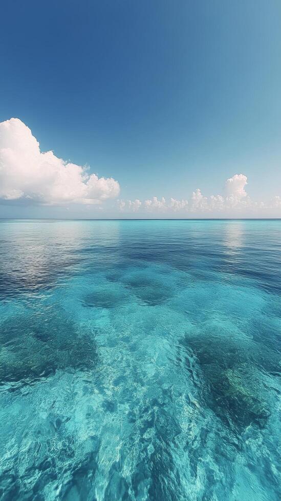 Clear turquoise water under a bright blue sky with fluffy clouds in a tropical paradise location photo
