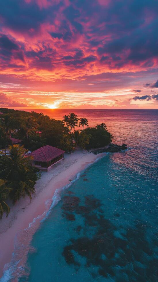 A serene sunset over a tropical beach with palm trees and calm waters photo
