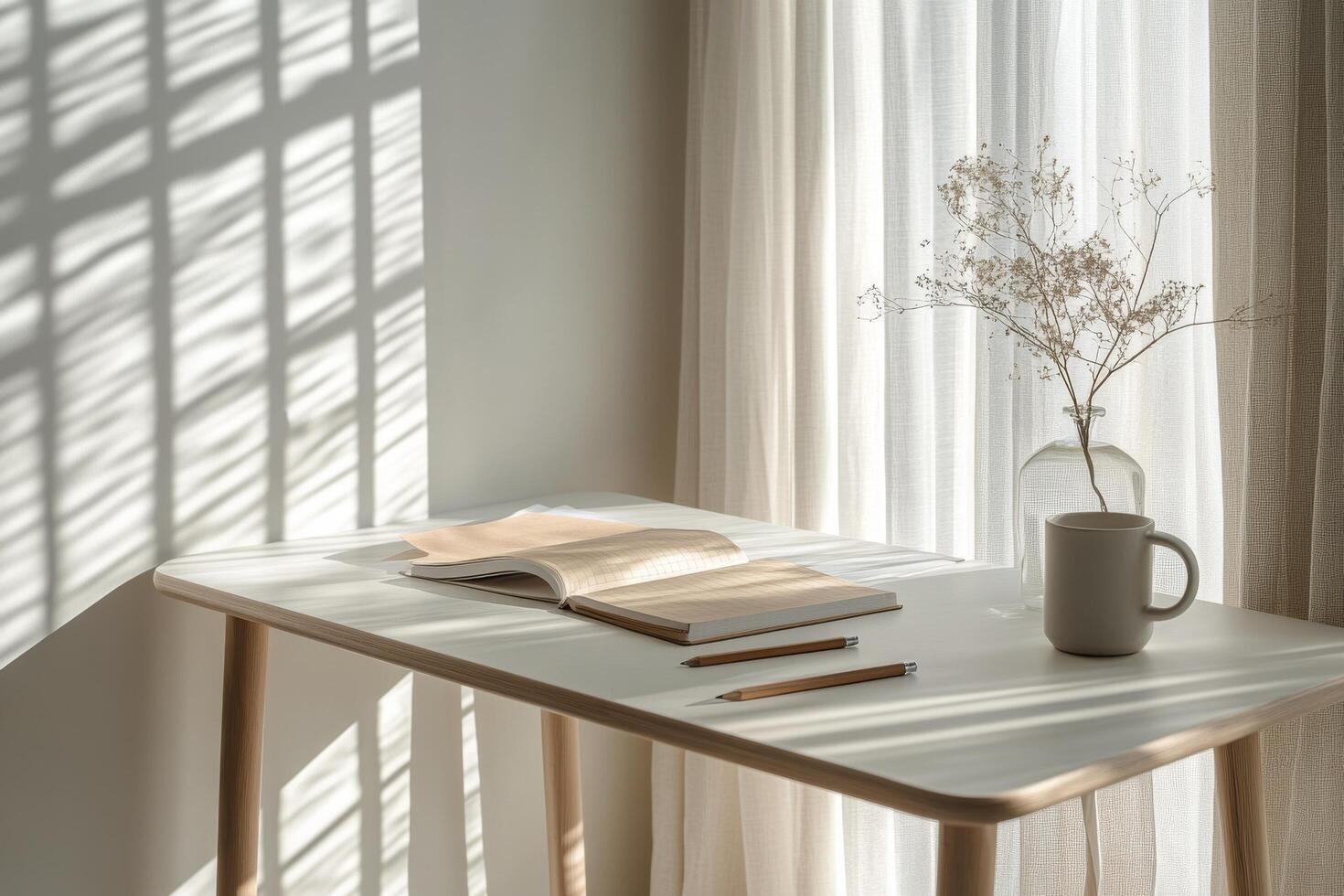 A serene workspace featuring a warm cup and neatly arranged notebooks in natural light photo