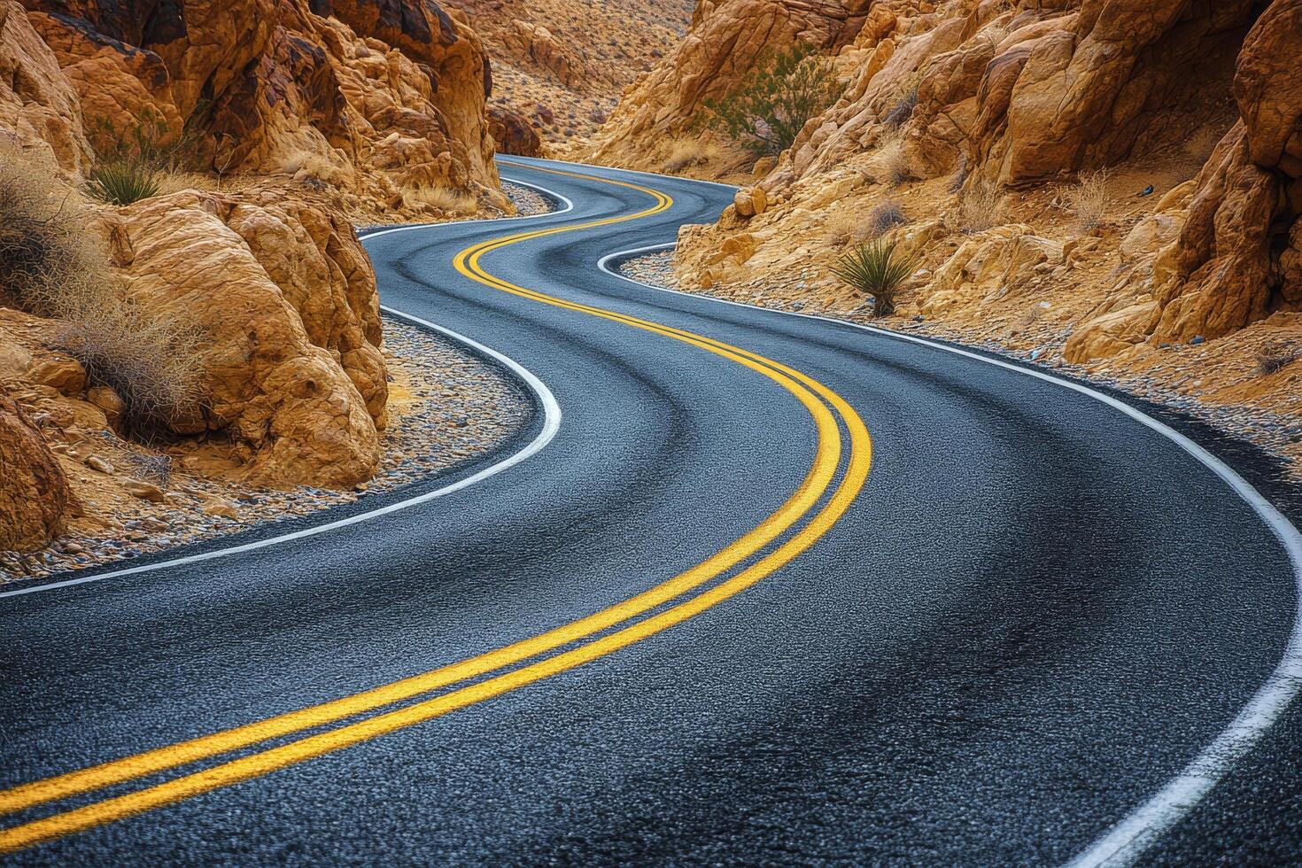 Curving mountain road winding through rocky terrain under cloudy sky during early morning photo