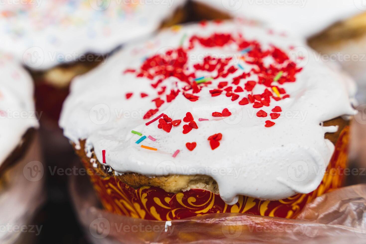 Tasty cupcakes topped with white frosting and vibrant sprinkles photo