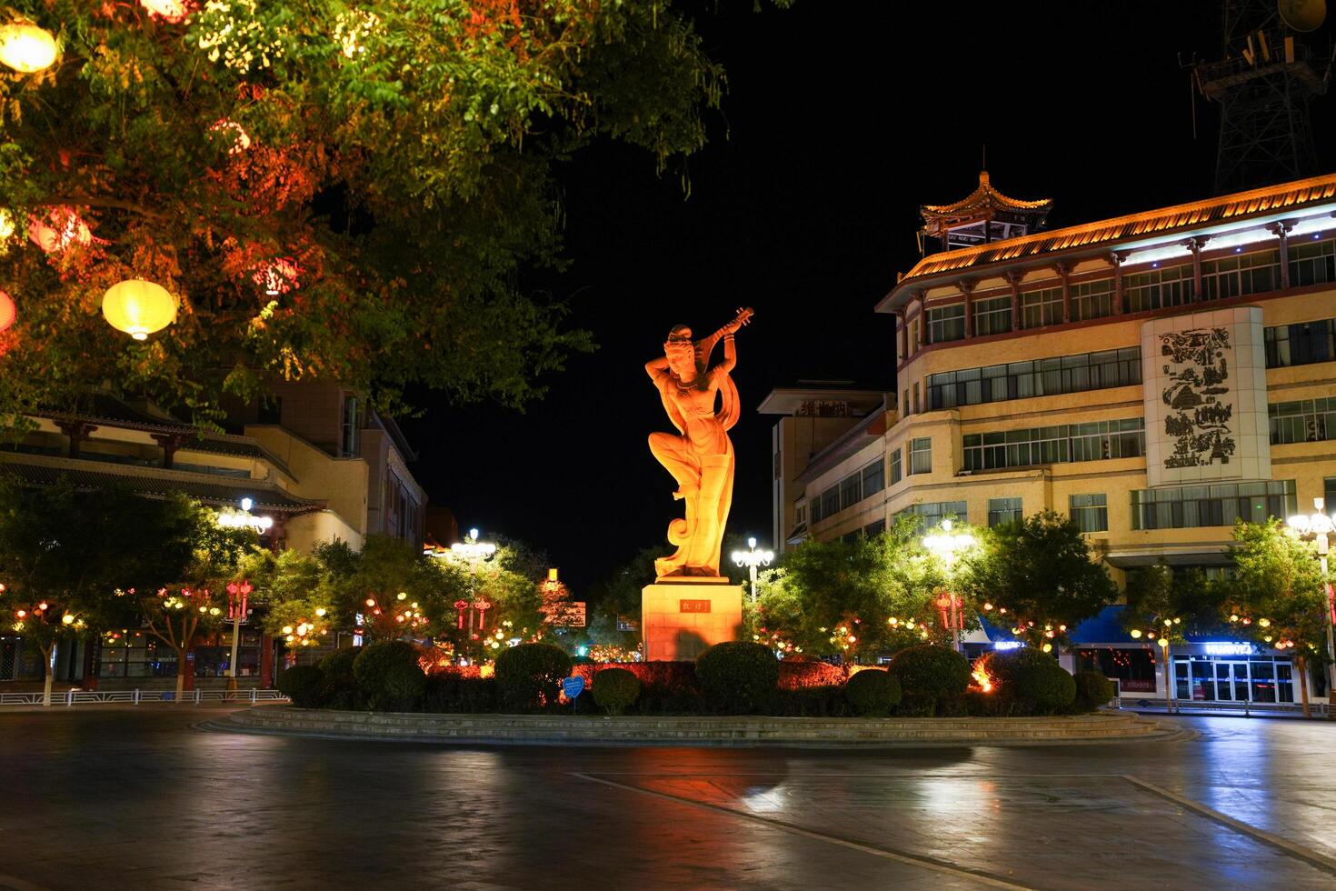 DUNHUANG, CHINA - OCT 20, 2024- Night view of flying Apsara statue in the center city of Dunhuang, Gansu, China photo