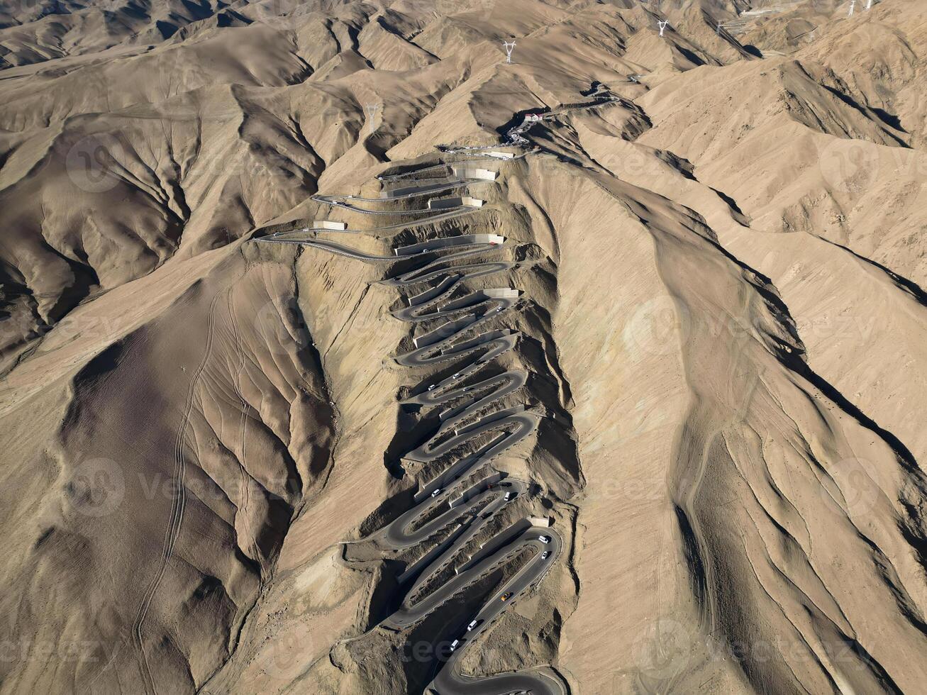 Scenic view of the winding hill road named Pan Long Ancient Road in Tashkurgan, Xinjiang, China. photo