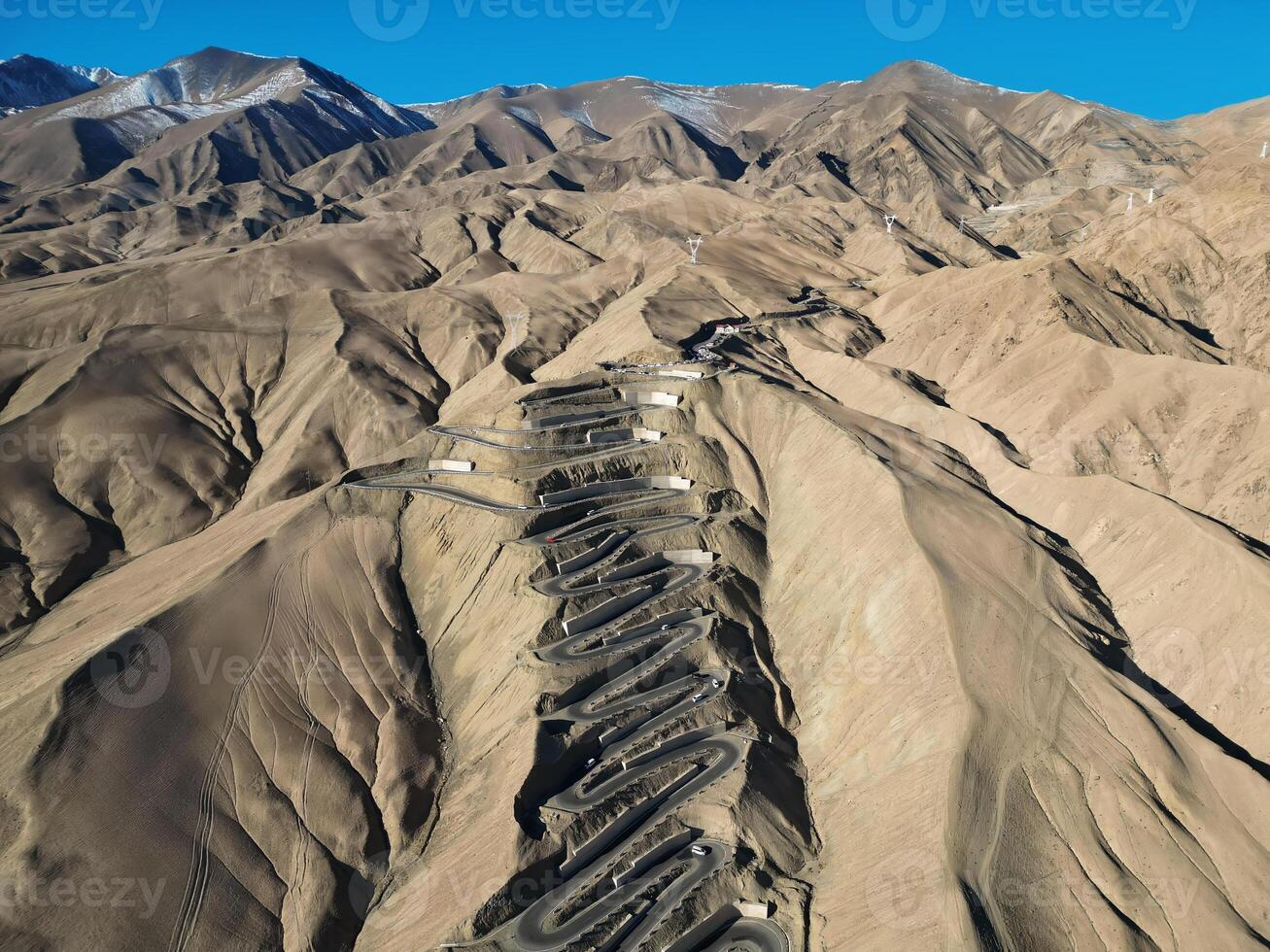 Scenic view of the winding hill road named Pan Long Ancient Road in Tashkurgan, Xinjiang, China. photo