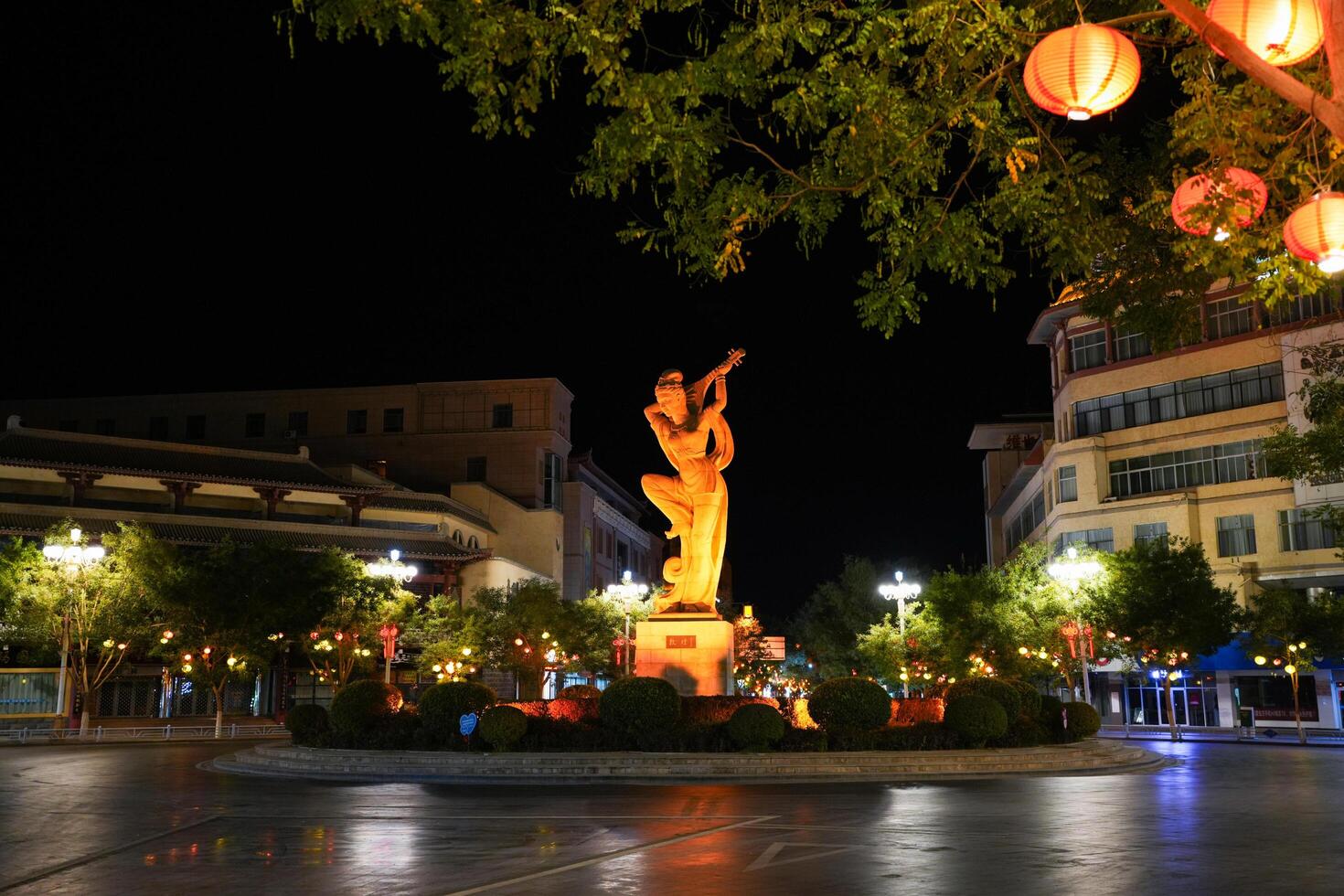 DUNHUANG, CHINA - OCT 20, 2024- Night view of flying Apsara statue in the center city of Dunhuang, Gansu, China photo