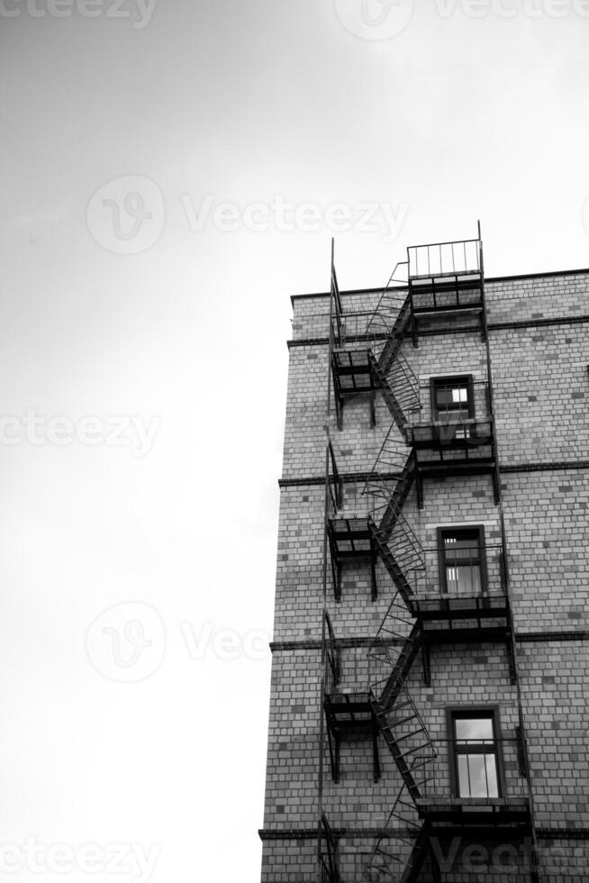 A tall building with fire escape stairs on it photo