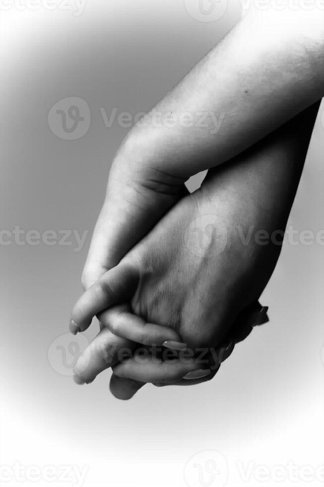 Two hands intertwined in a gentle embrace reflecting unity and connection photo
