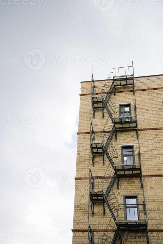 A tall building with fire escape stairs on it photo