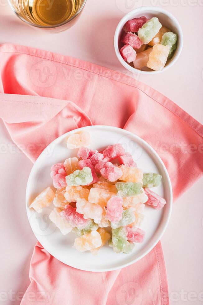 Freeze dried chewy candies on a plate on a table top and vertical view photo