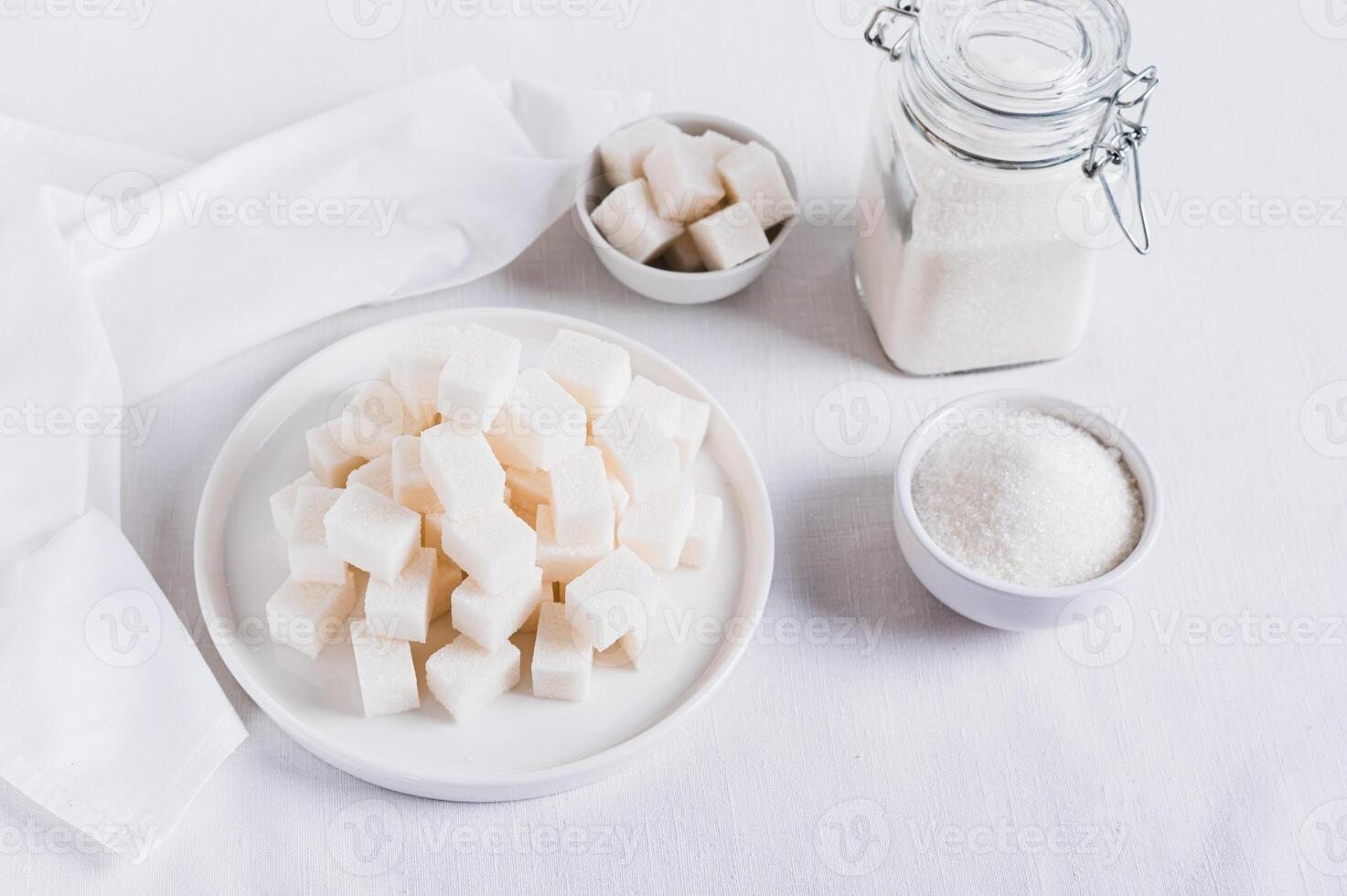 Alternative choice between lump sugar and granulated sugar on white background photo