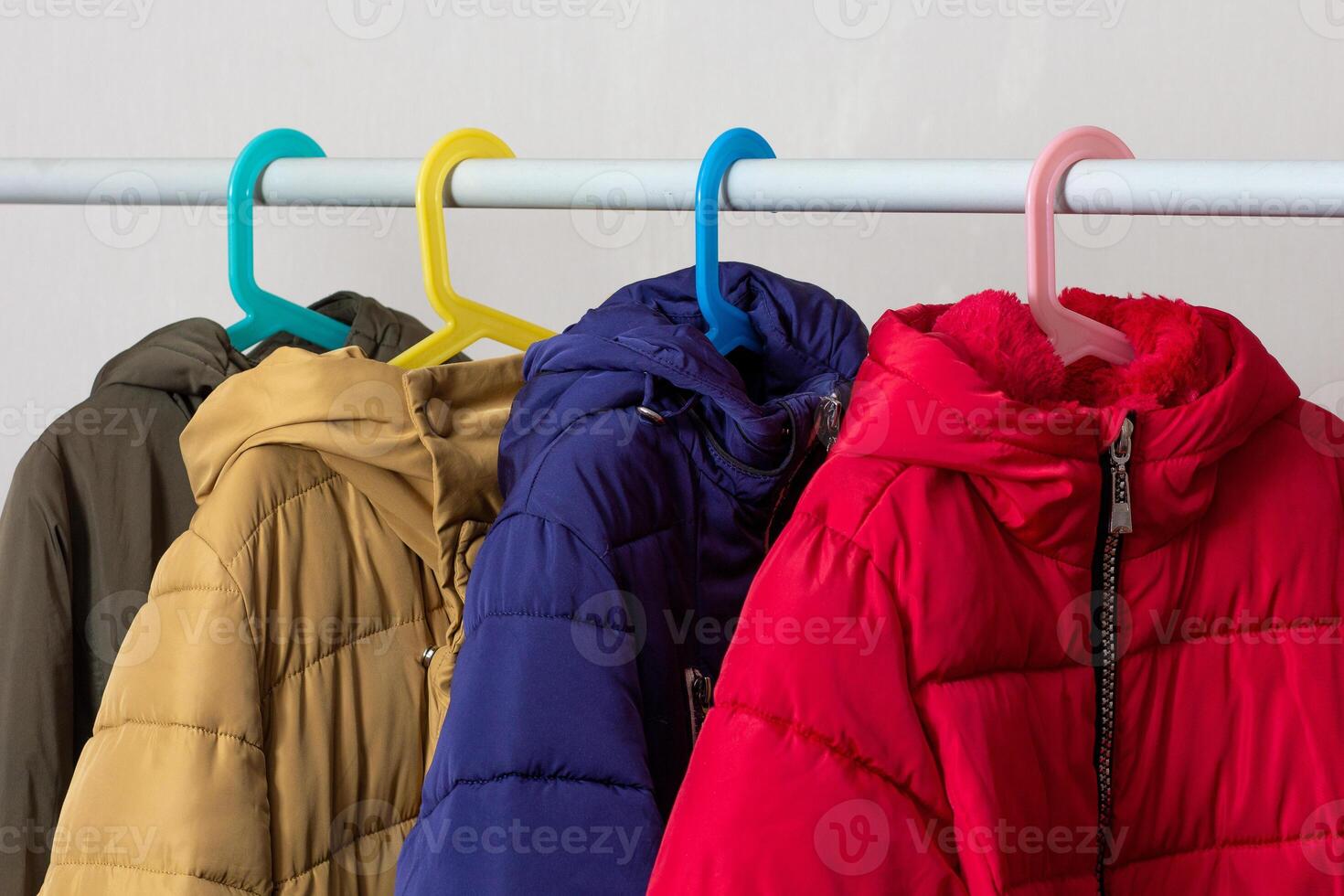 Rank of puffer coats hanging photo