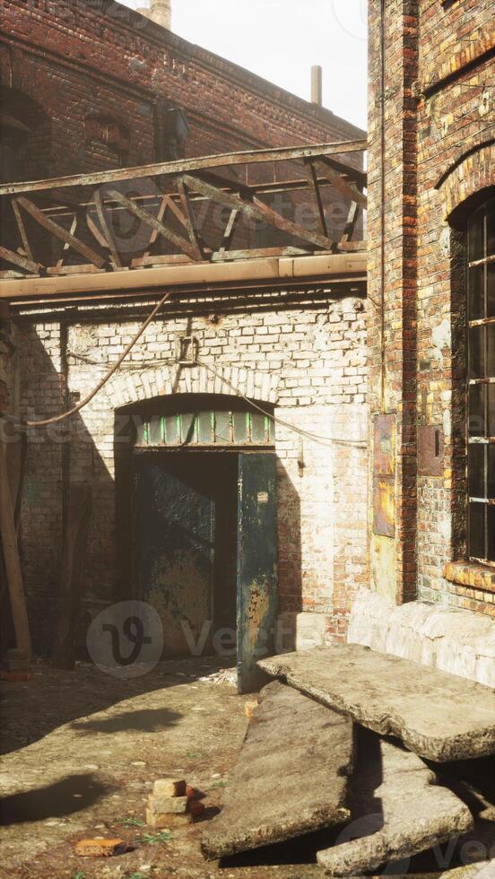 Sunlit Abandoned Factory Courtyard, vertical photo