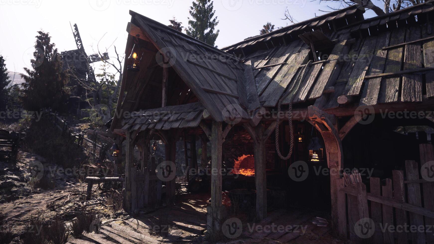 Abandoned rustic cottage in a forest with a glowing forge at dusk photo