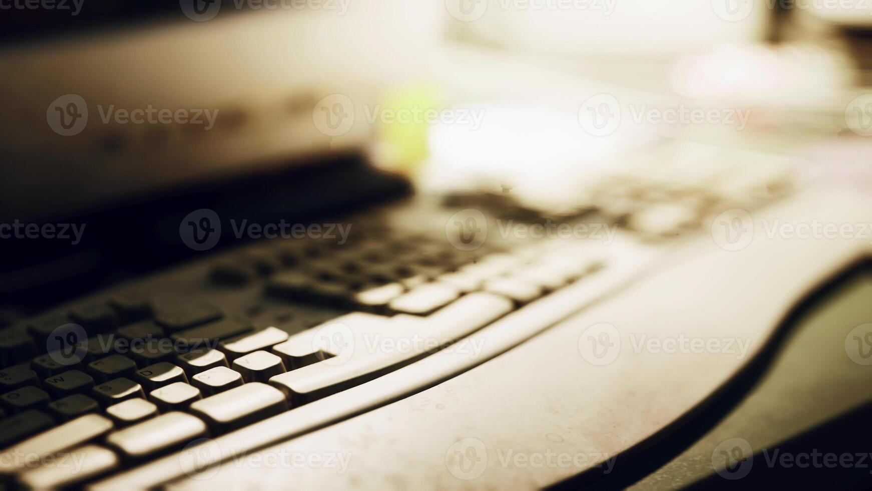 A close up view of a keyboard on a desk with soft ambient lighting photo