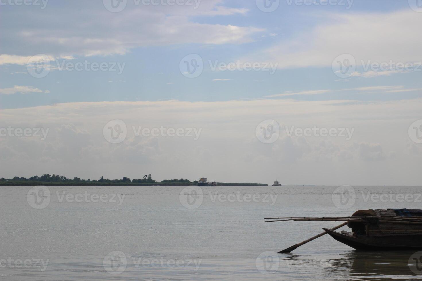 A peaceful scene of a boat gently floating down a calm river photo
