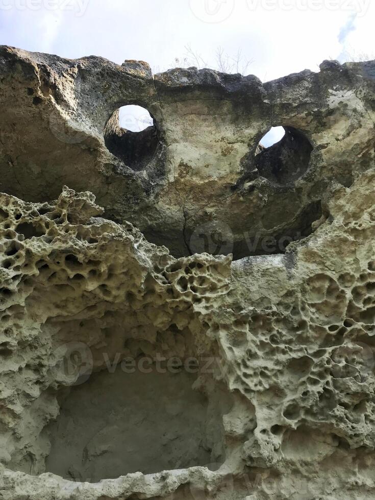 Natural rock in the form of a flying demon. Smiling bat. Bakla, Crimea. photo