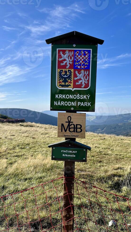 Information sign on the mountain hiking trail leading to the top of Mount Sniezka, Poland. photo