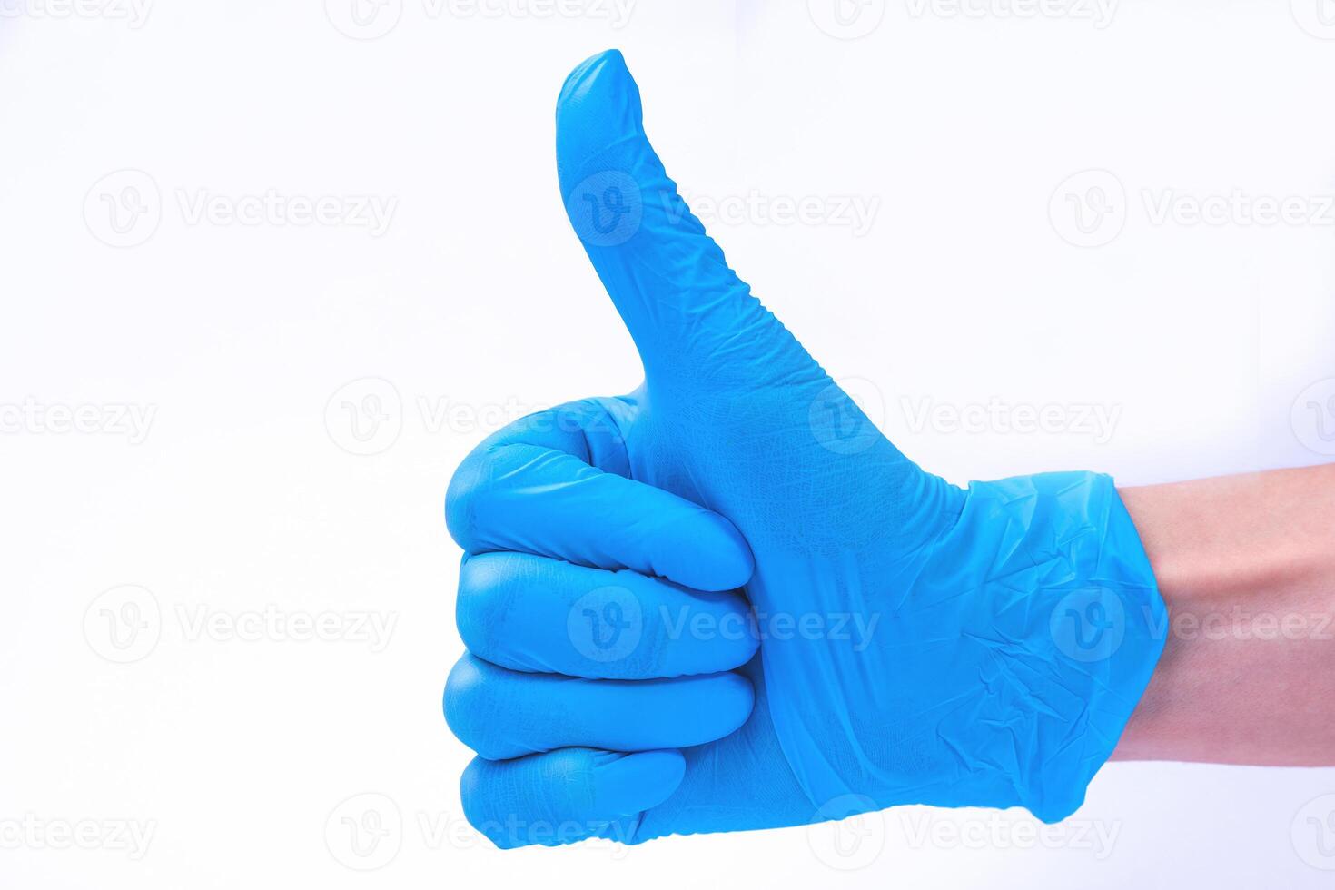 Like, hand in blue medical glove with thumb up. Hand gesture. White background photo