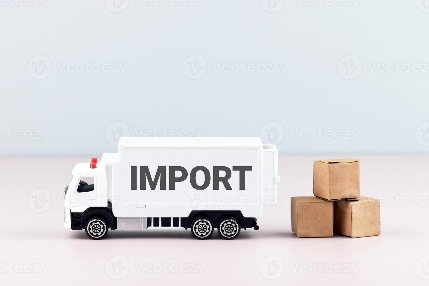 White toy truck on blocks with the text IMPORT. photo