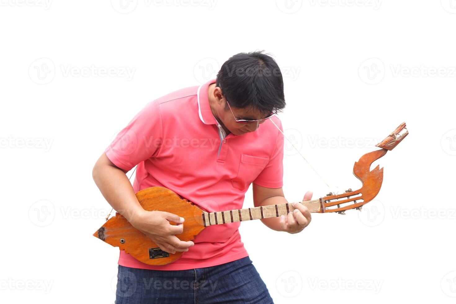 Asian man is playing Thai traditional lute, folk guitar. Concept, love music, hobby, recreation activity. Relax time. Music can develop mental health. photo