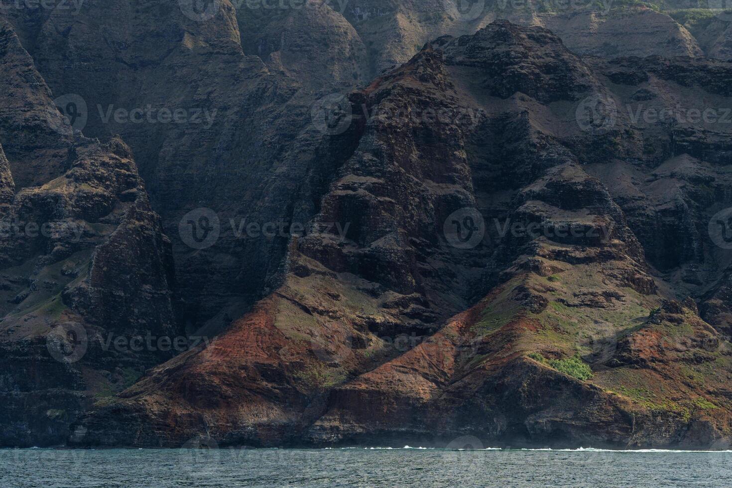 The Napali Coast of Kauai, Hawaii as viewed from a boat on the Pacific Ocean. photo