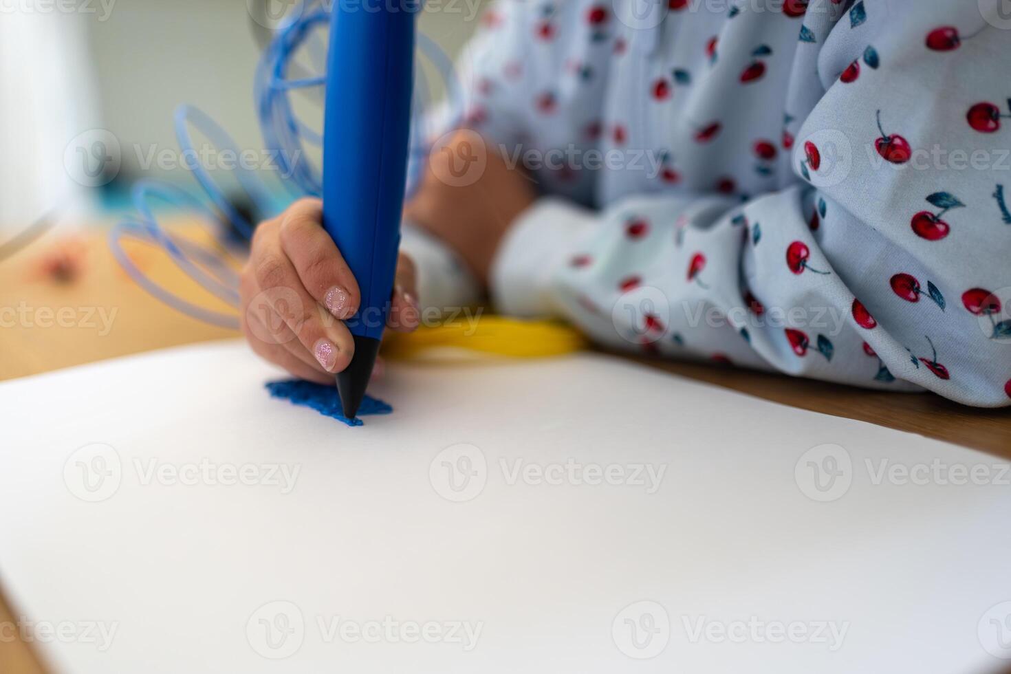 Crop girl creating plastic 3D model on drawing paper photo