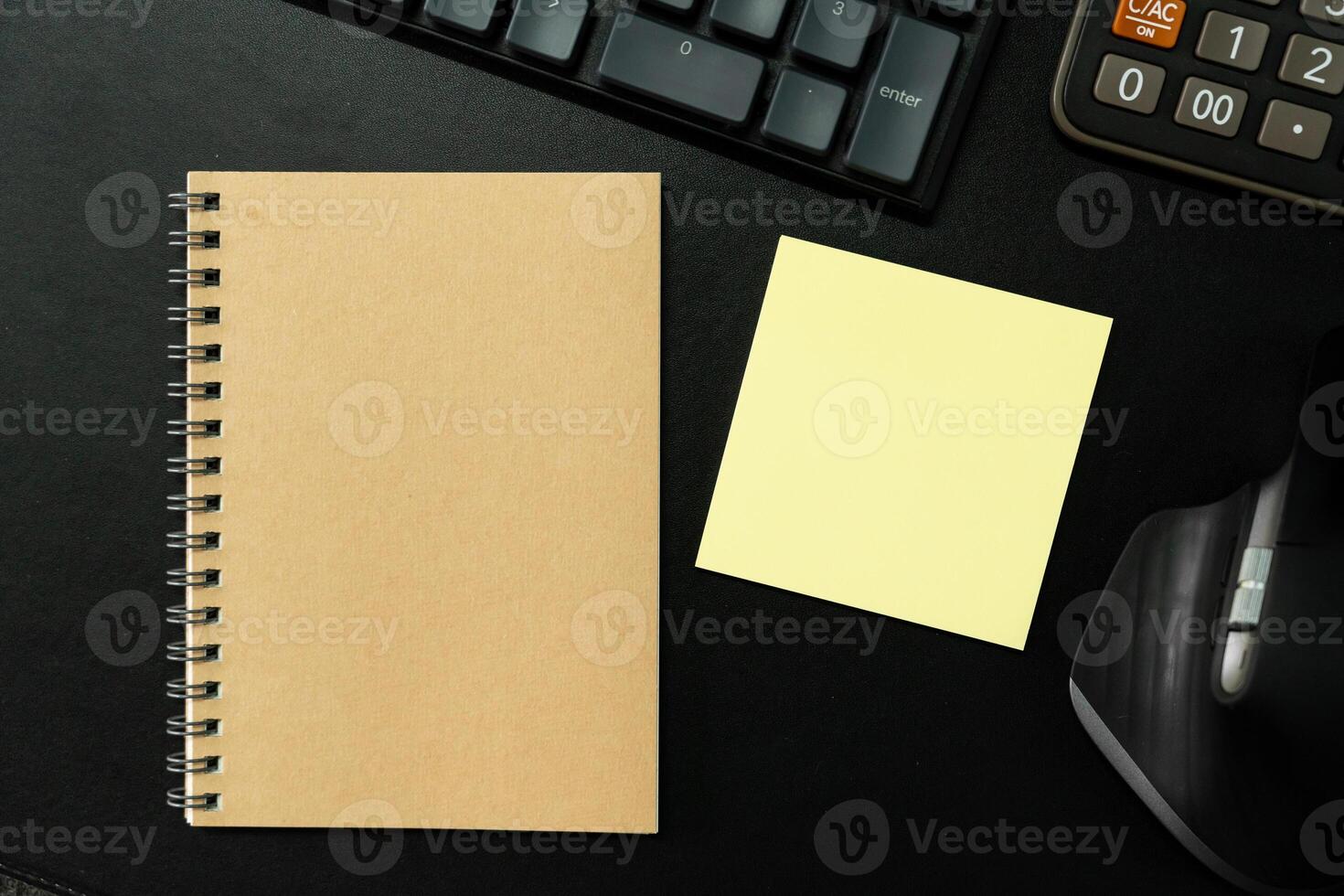 Top view of notebook. Blank paper notepad on office desk table with keyboard and other supplies. Blank notebook page for input the text. copy space, flat lay. photo