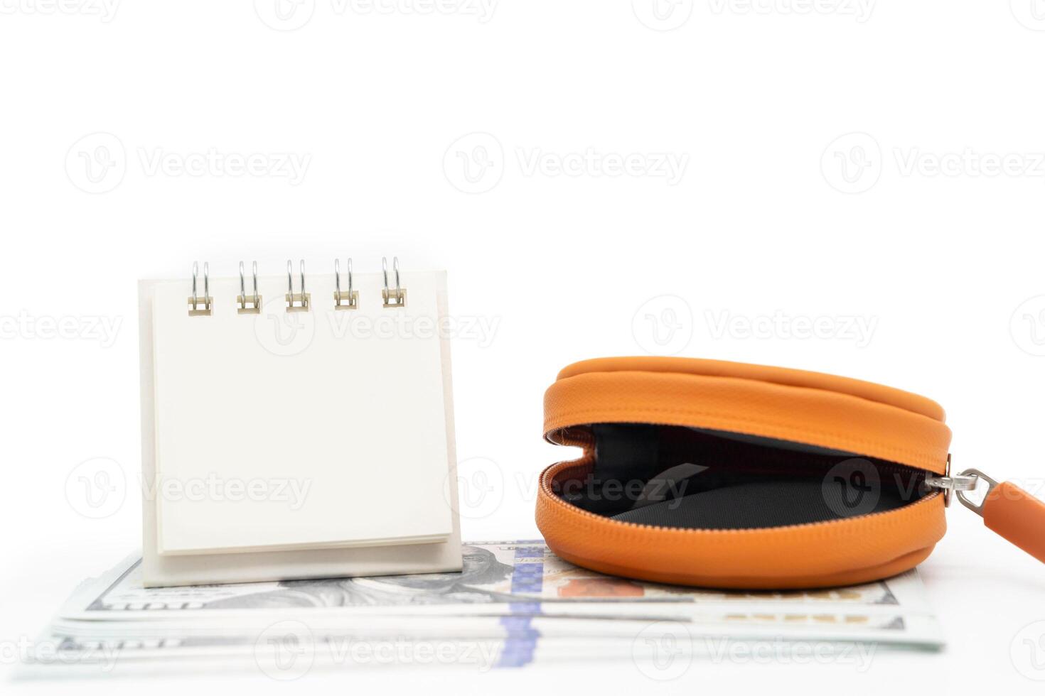Open Orange Coin Pocket and Blank Calendar isolated on white background with copy space. Financial crisis, poverty, lack of money concept. Open empty coin wallet. photo
