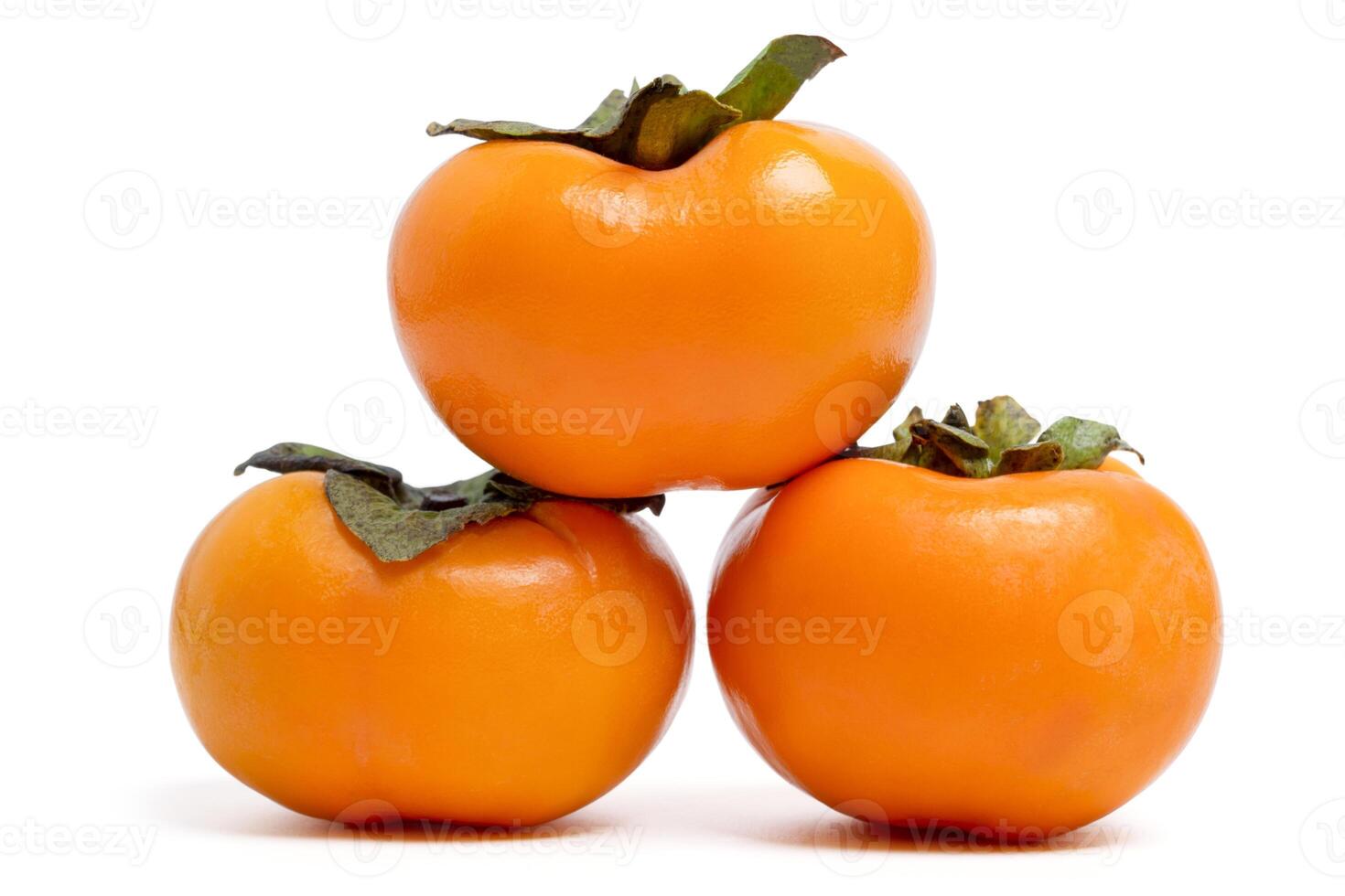 group fresh ripe persimmons fruit on white background. photo