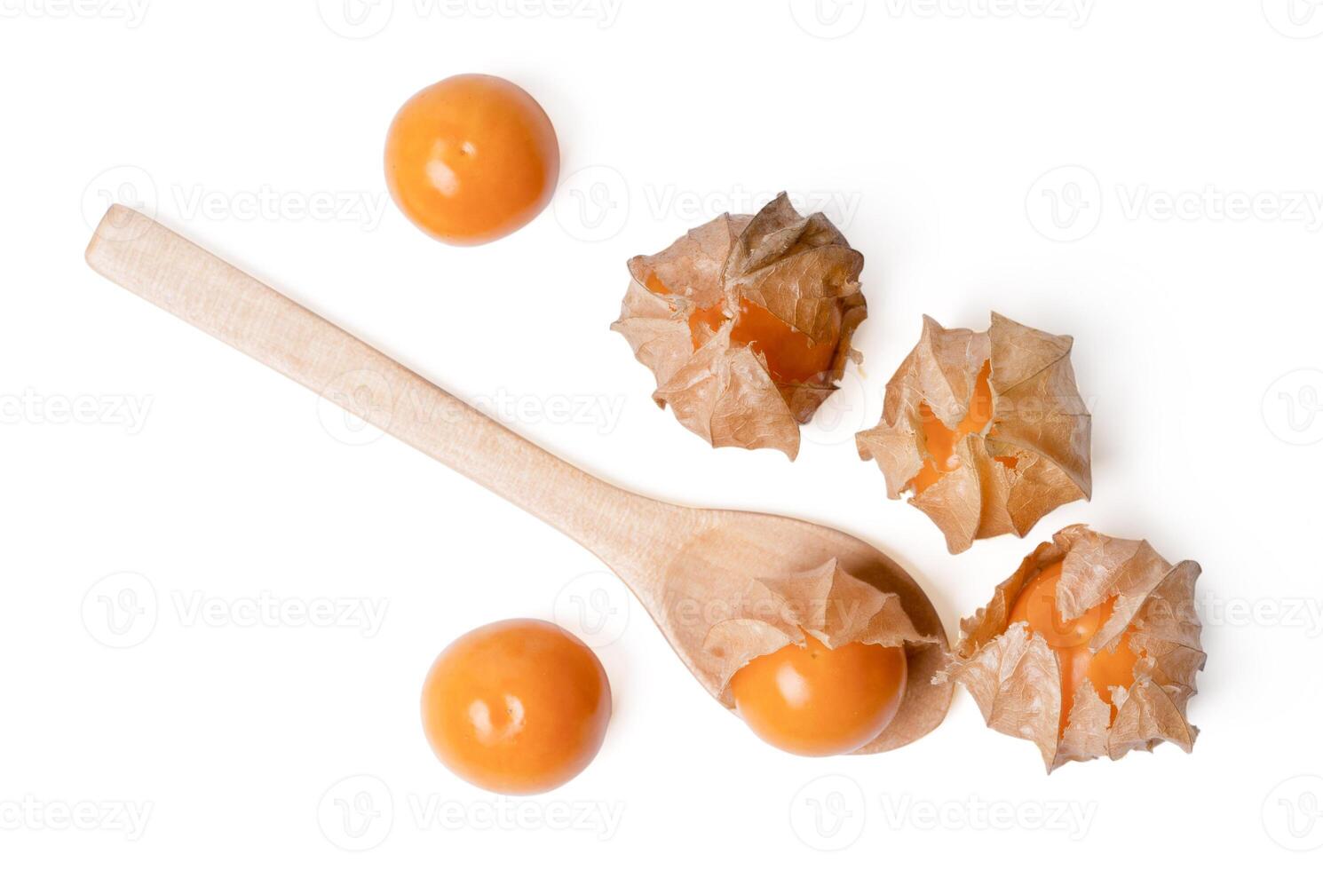 Physalis berry with on wooden spoon white background. photo