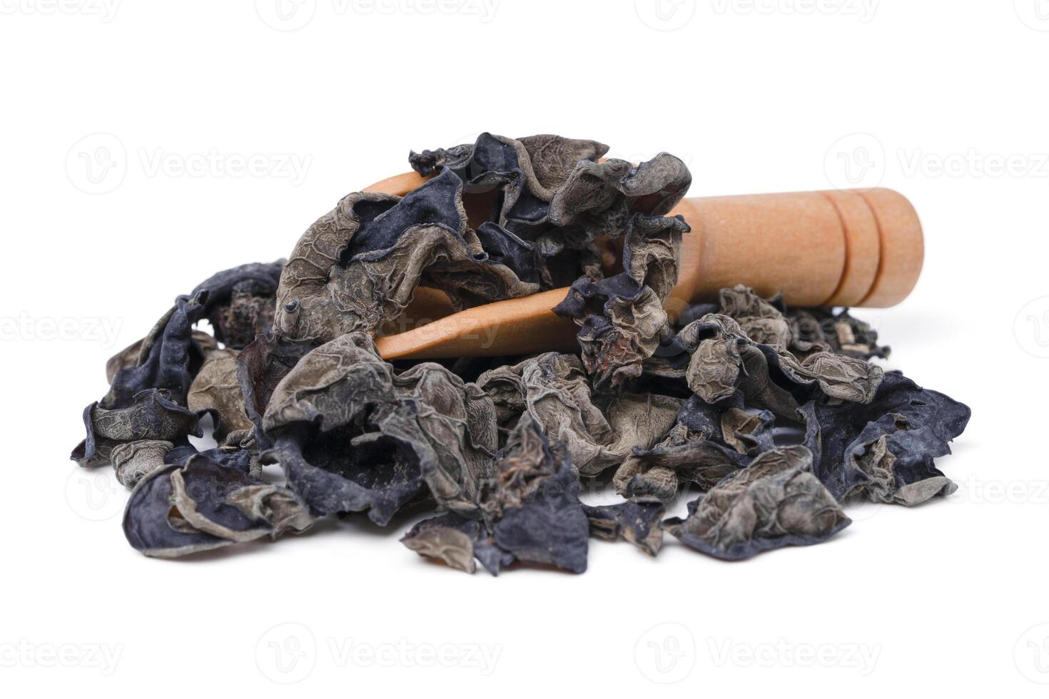 view black fungus or ear mushroom in wooden scoop on white background. photo