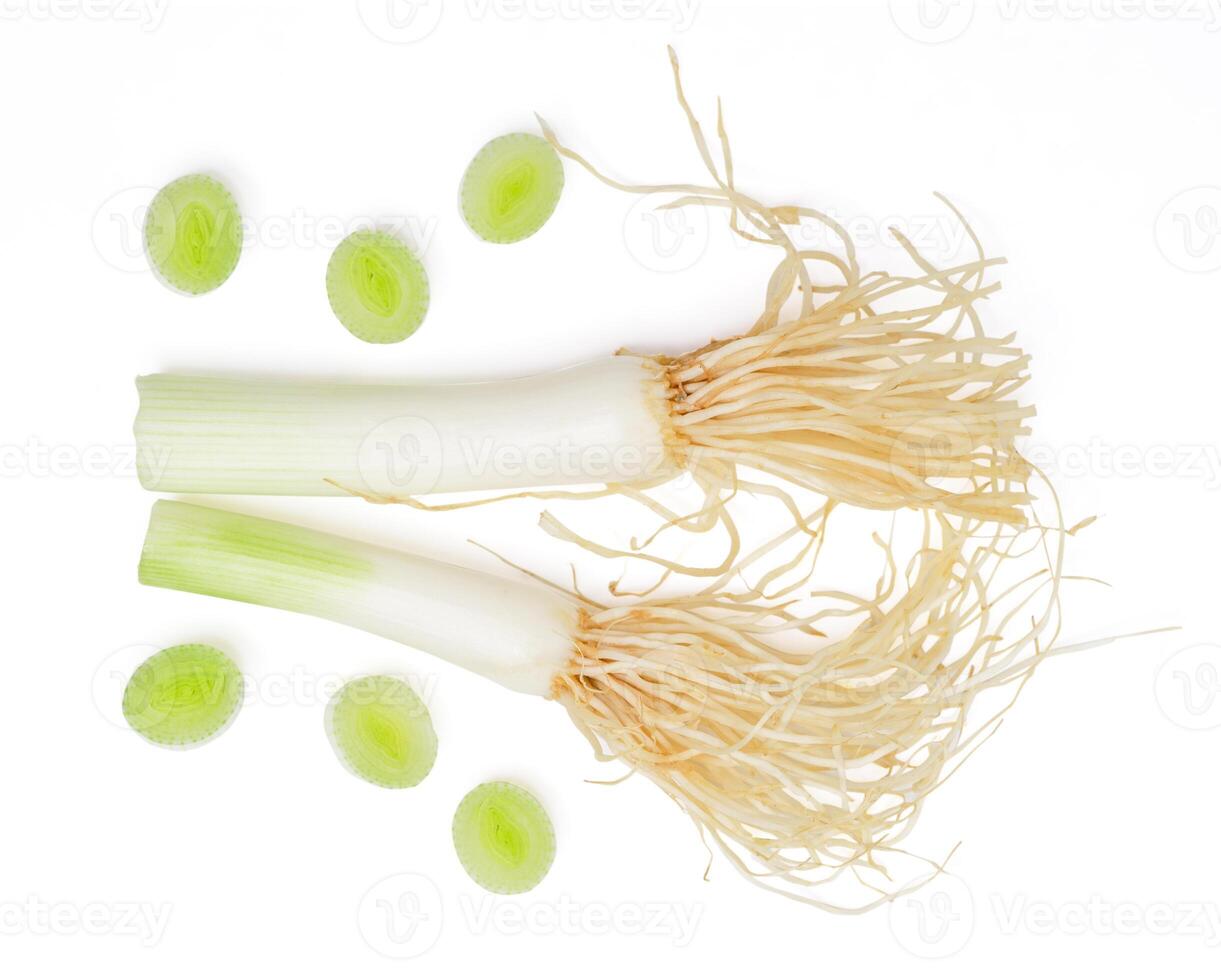 Top view slice spring onions with root on white background. photo