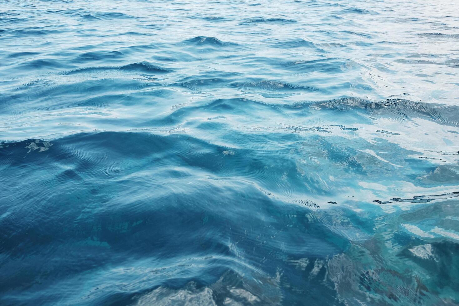 Emerald green waters and turquoise surface of blue sea wave and water background. Travel destination summer of ocean photo