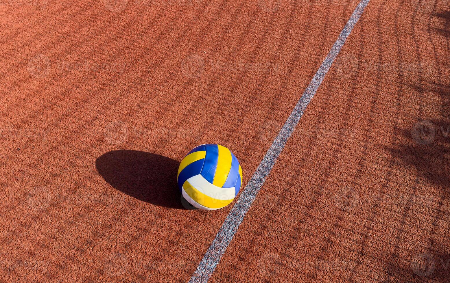volleyball. blue with yellow color ball on the playground. volleyball cover, red. ball game photo
