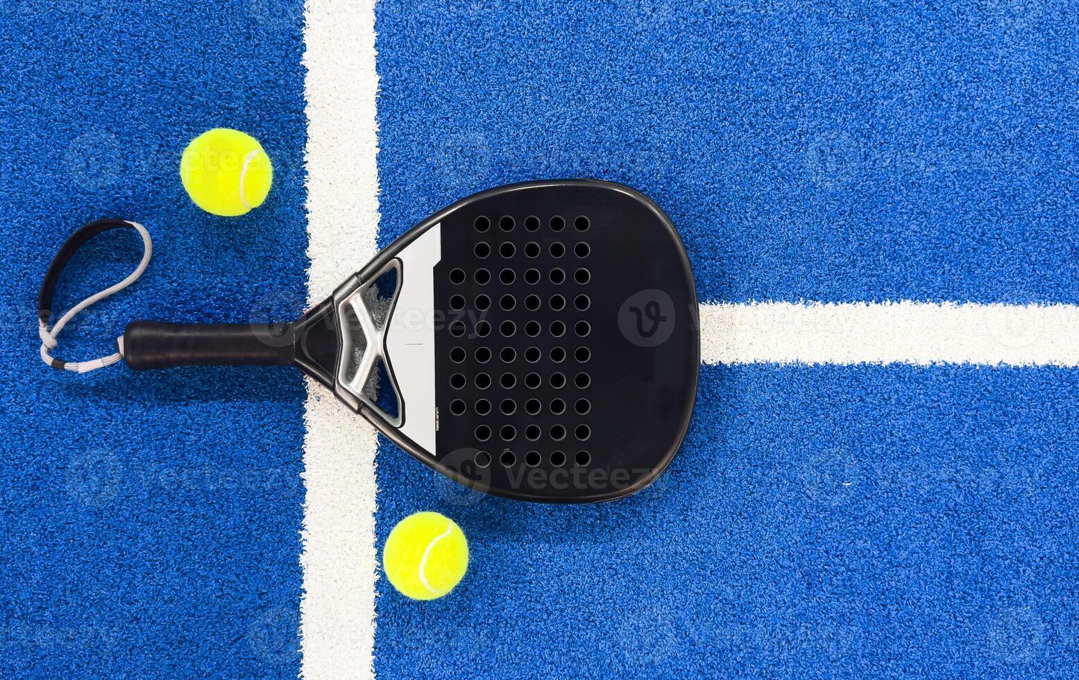 Black professional paddle tennis racket and ball on blue background. Horizontal sport theme poster, greeting cards, headers, website and app photo