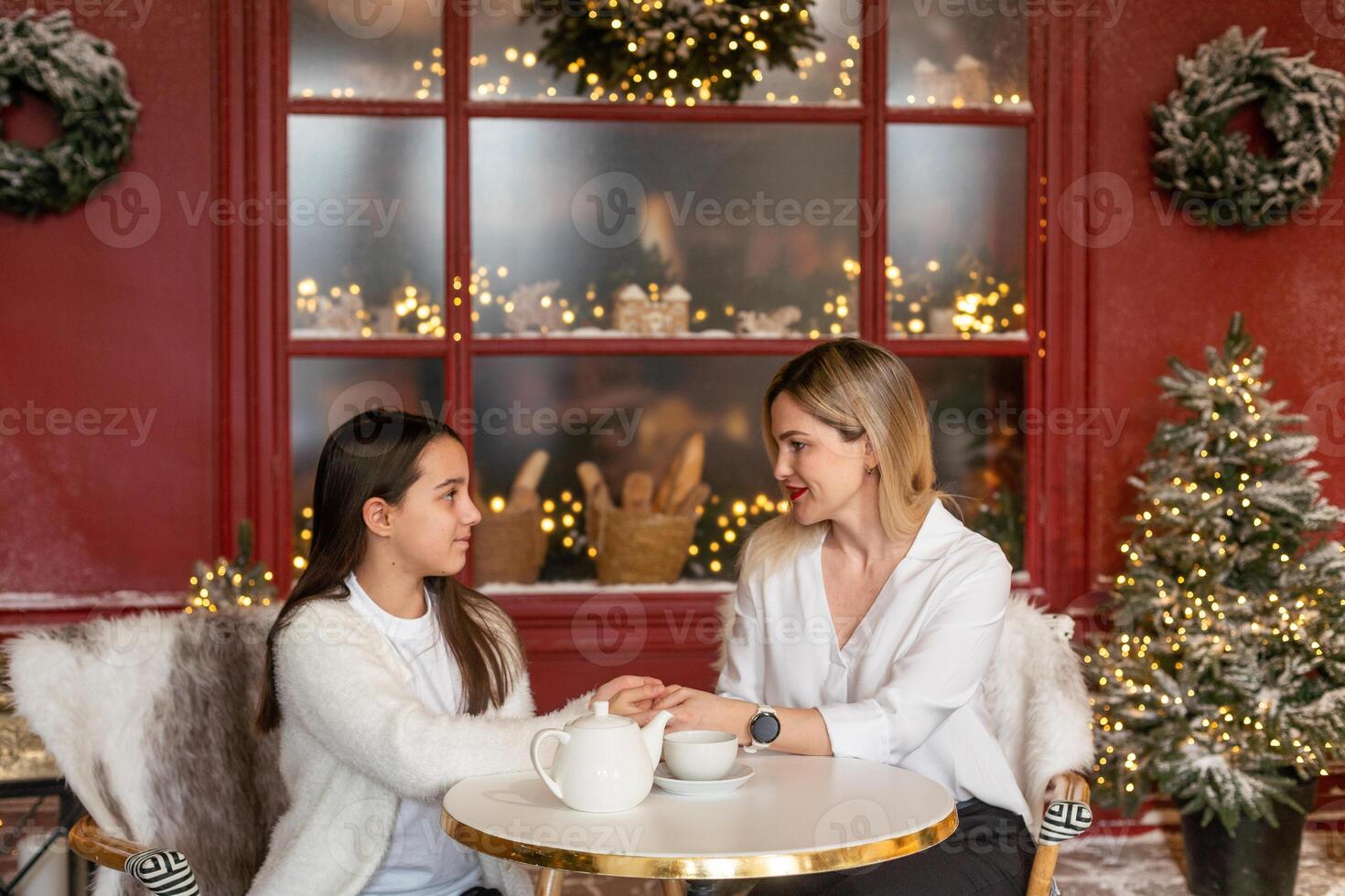 happy family mom and daughter are drinking tea photo