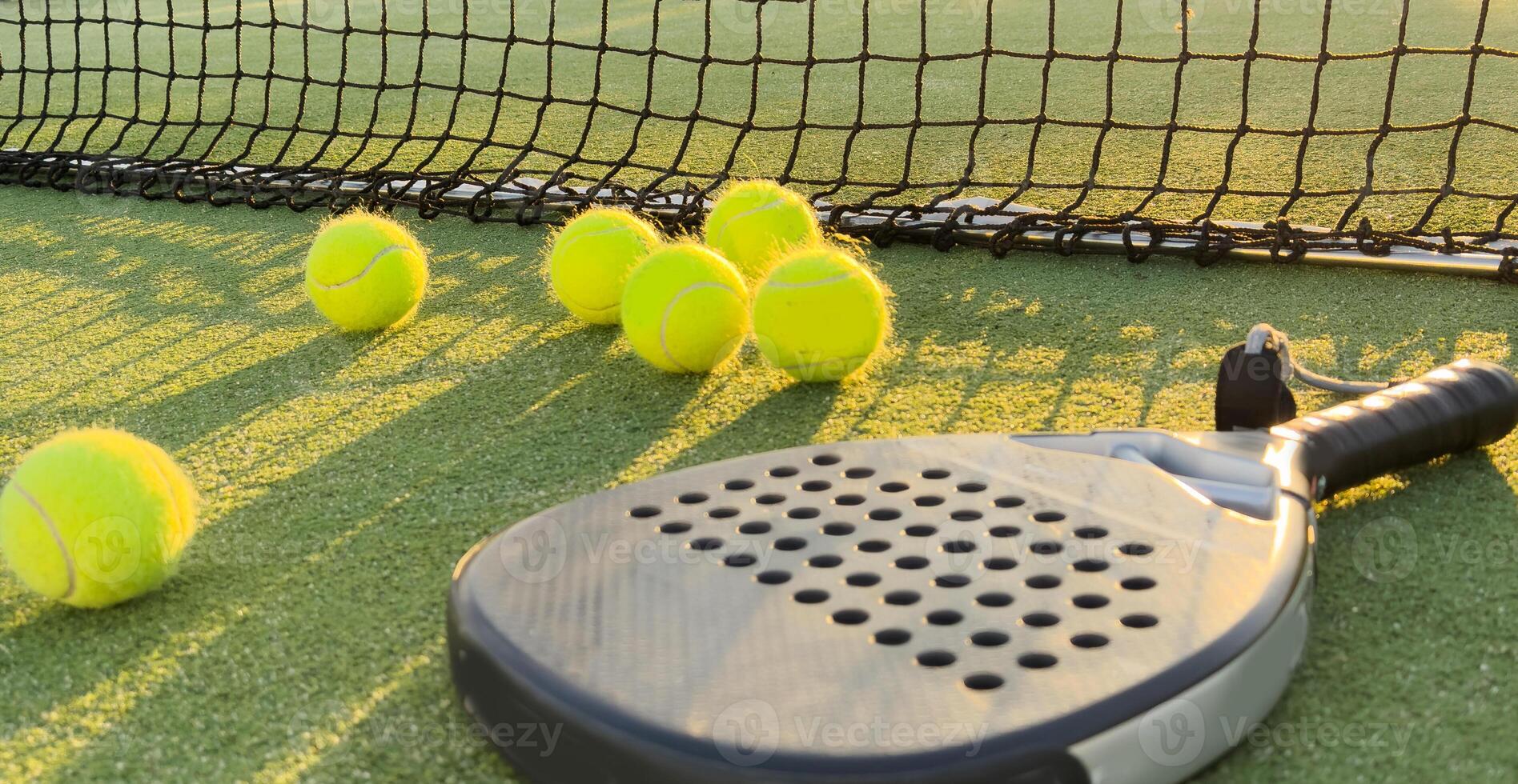 Background of padel racket and ball on artificial grass floor in outdoor court. Top view. photo