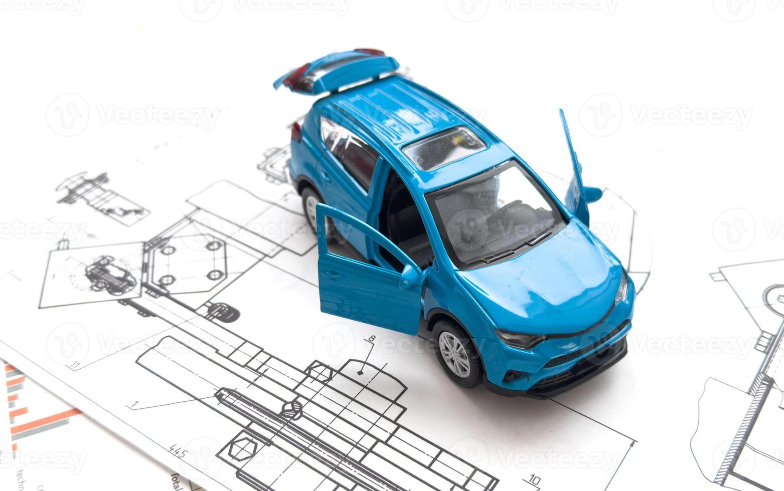 Small toy car close up image on blueprint background. photo