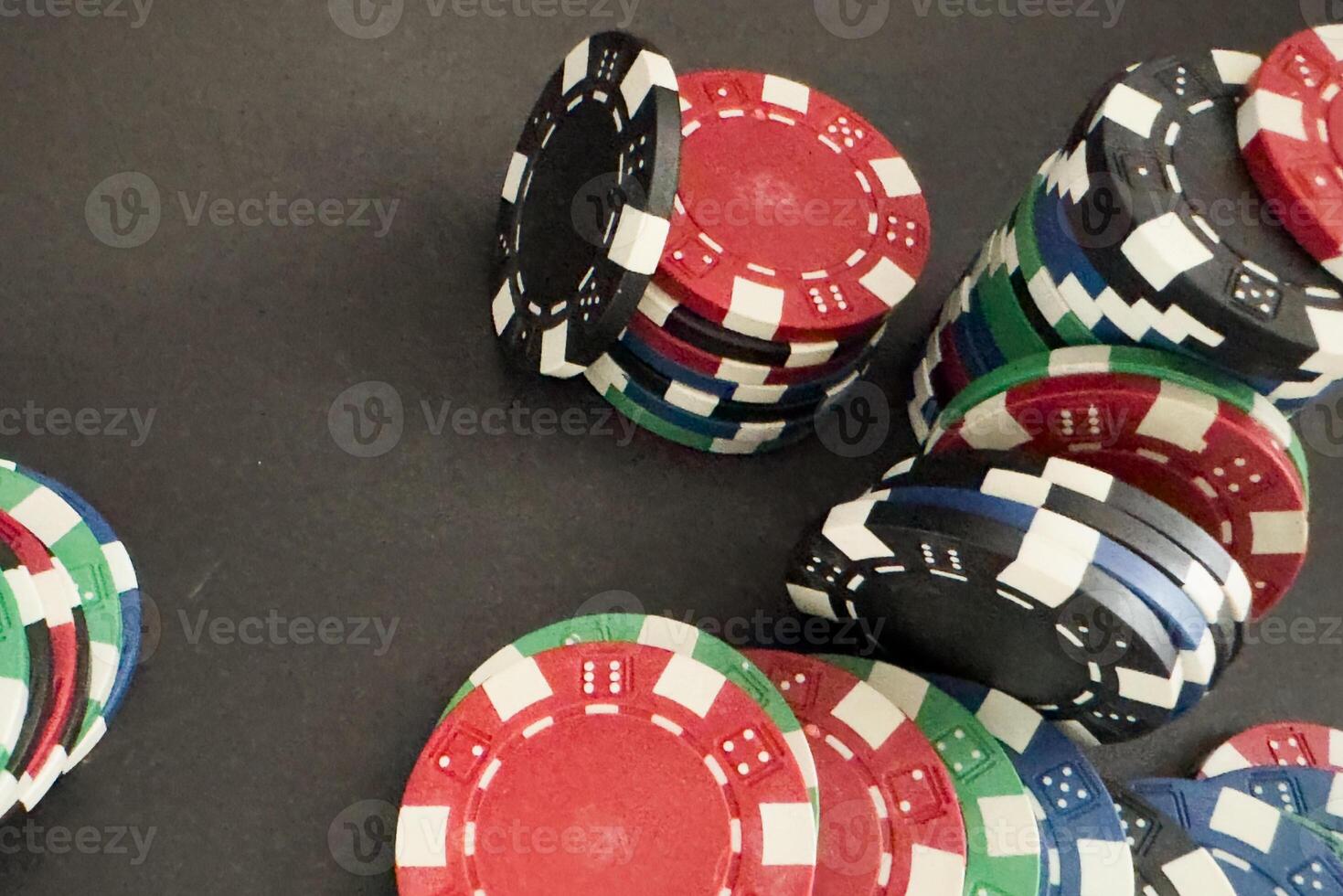 red dice, cards and poker chips, on a black background photo