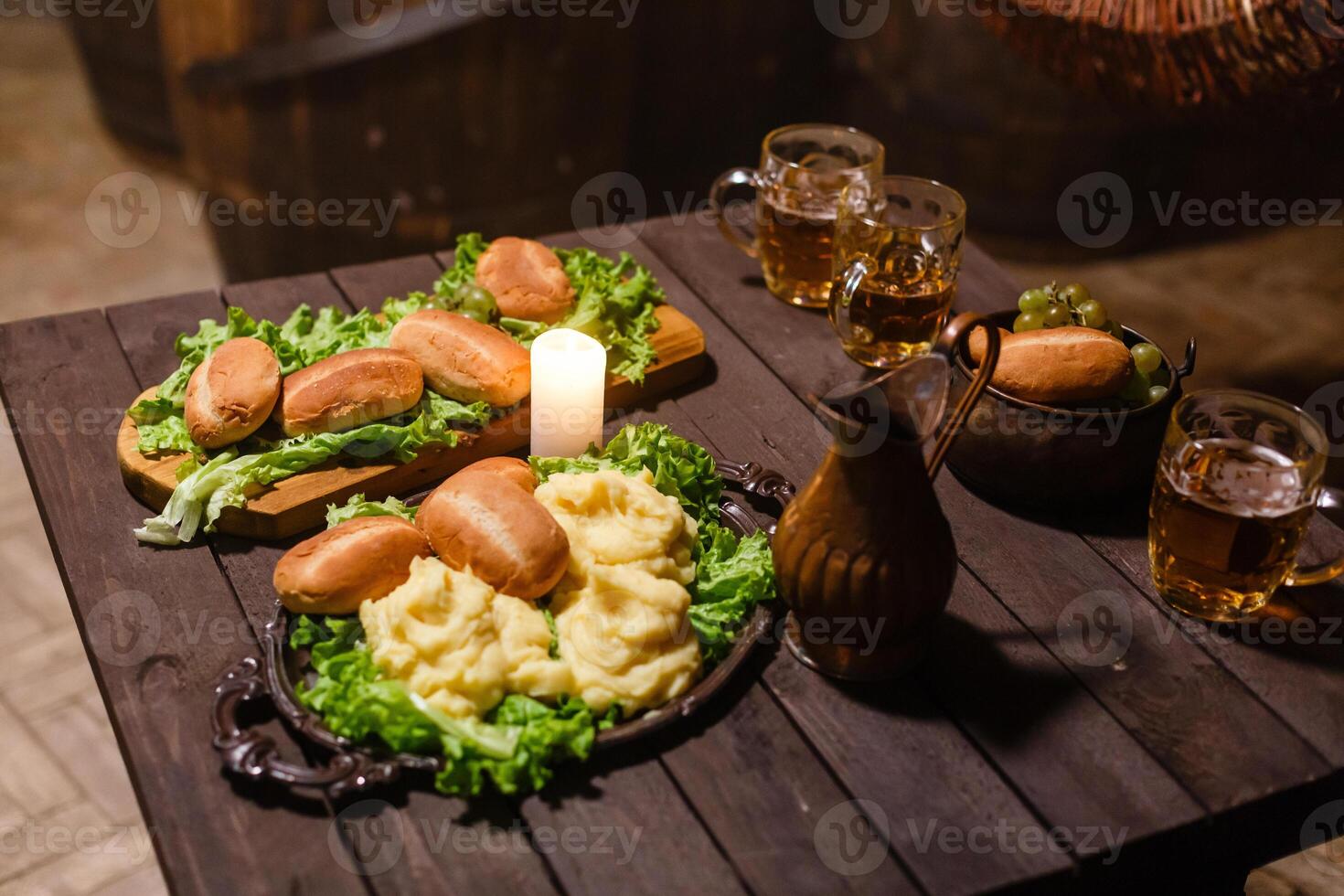 Lanterns on table with beer. candlesticks and beer on a wooden old table. photo