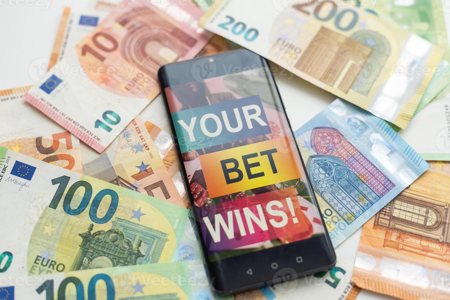 Smartphone with gambling mobile application with money close-up. Sport and betting concept photo