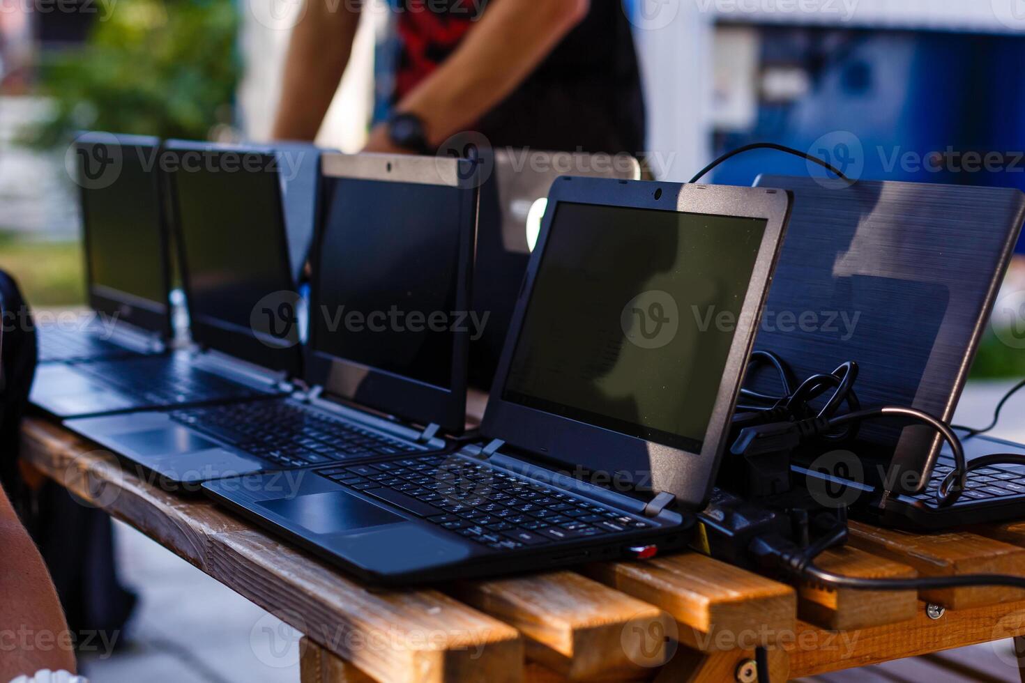 laptops on a wooden table in the park photo