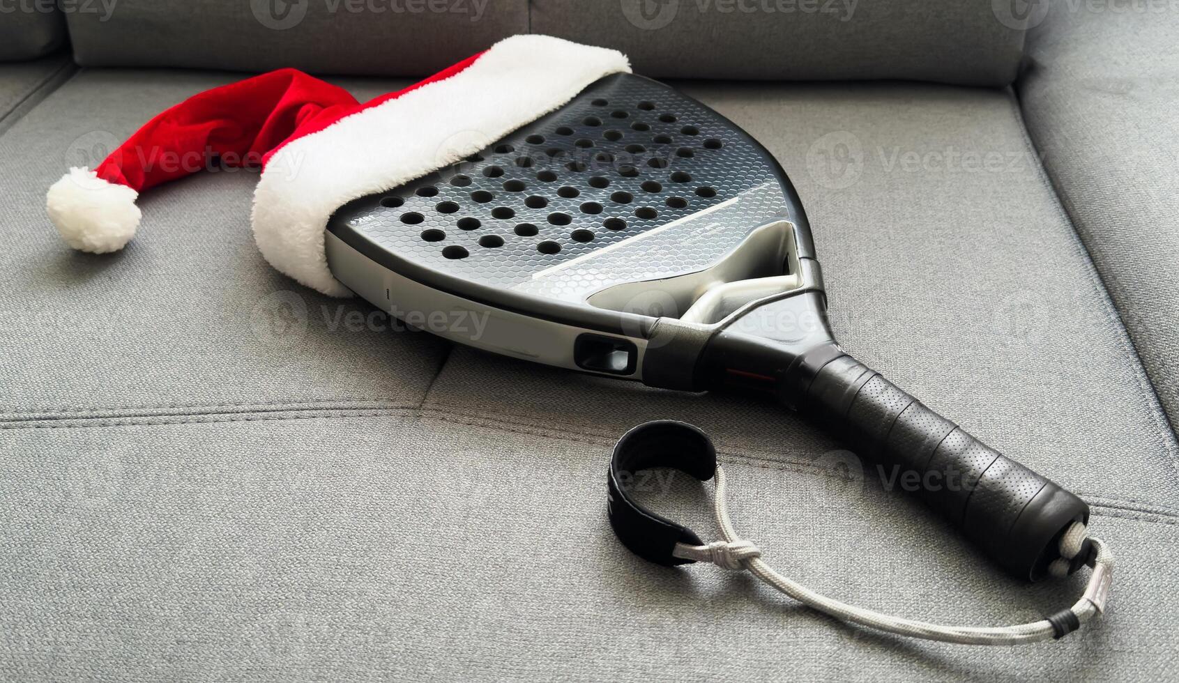 padel racket and santa hat photo
